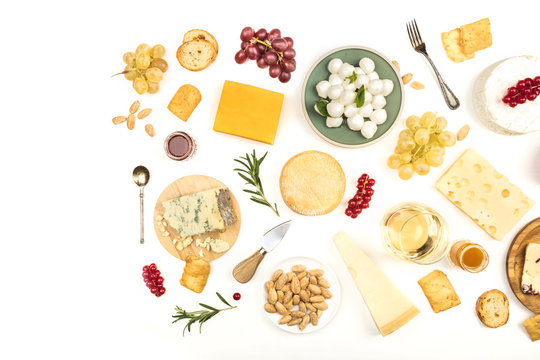 Various types of cheese with wine on a white background with copy space