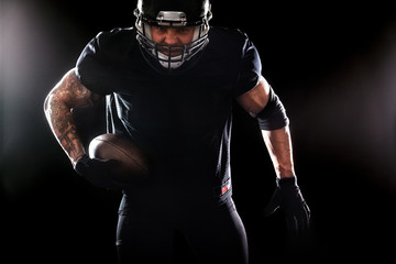 American football sportsman player isolated on black background