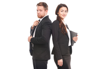 Portrait of Caucasian businessman and Asian businesswoman cooperating