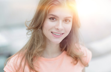 closeup portrait of a young woman on blurred background.