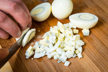 Fototapeta na wymiar Cut boiled eggs to prepare different dishes.