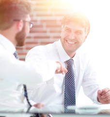 Colleagues shake hands as a sign of success