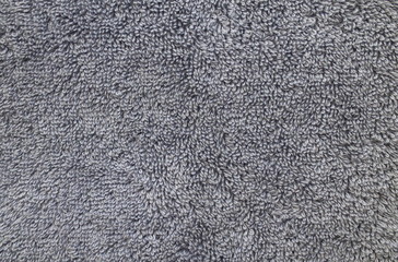 A grey cotton towel photographed in even lighting provides a textured background