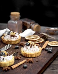 sweet cakes with white cream and chocolate powder