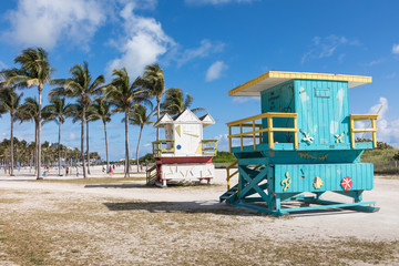 Lifeguard tower in a colorful Art Deco style, with blue sky and Atlantic Ocean in the background. World famous travel location. Miami Beach.
