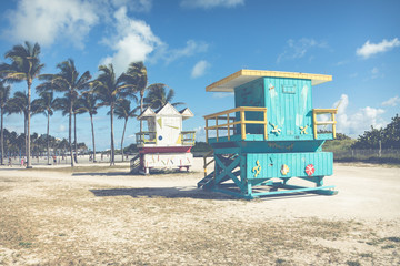 Lifeguard tower in a colorful Art Deco style, with blue sky and Atlantic Ocean in the background. World famous travel location. Miami Beach.