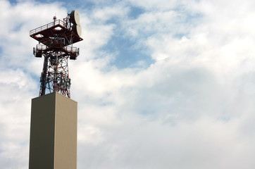 Naklejka premium Satellite tower against blue cloudy sky