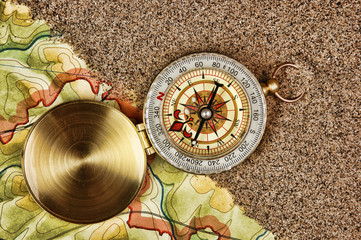 compass on the map with sand