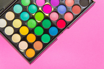 Eyeshadow on  pink background. Decorative cosmetics for professional makeup. Concealers. Eyeshadow trend colors, glamour makeup