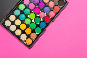 Eyeshadow on  pink background. Decorative cosmetics for professional makeup. Concealers. Eyeshadow trend colors, glamour makeup