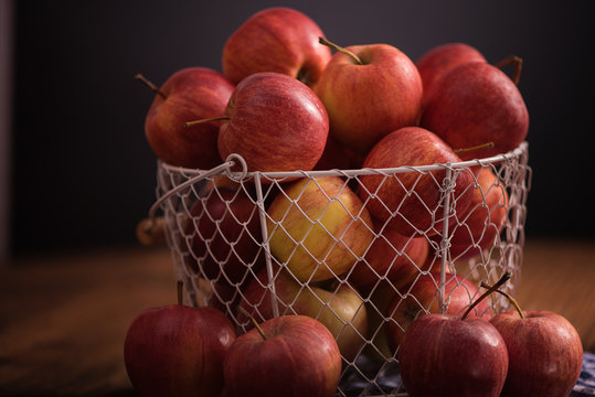 backet full of apples on wood table background 