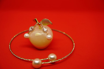 Pearl Earring and necklace isolated on red background