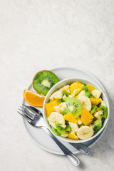 Citrus fruit salad on white background. Top view, copy space.