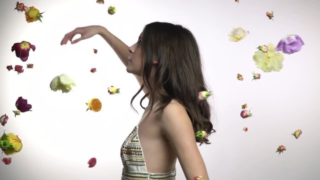 Girl dances among flowers on a white background
