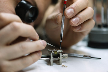 Close up of watchmaker repair mechanical watch