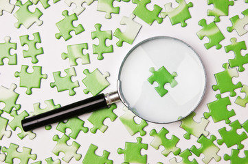 magnifying glass on the green puzzle