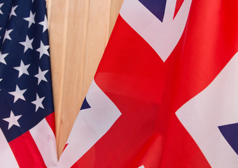 Fototapeta na wymiar USA flag and UK Flag on wooden background light.