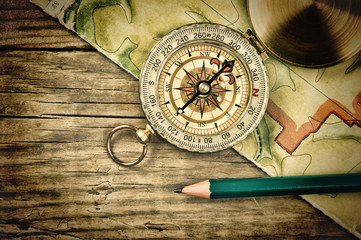 old map and compass on a wooden table