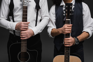 cropped shot of duet of musicians with acoustic guitars