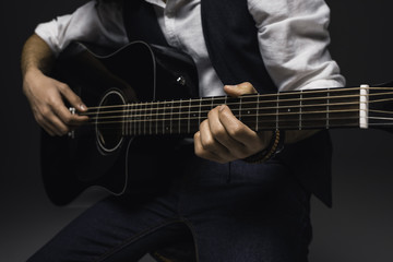 Fototapeta na wymiar cropped shot of man playing acoustic guitar