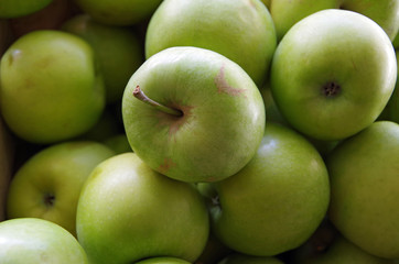 Green apples in wooden crates