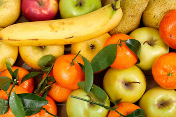 close up of different fruits , apples, tangerines, banana