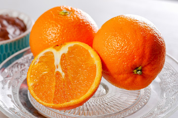 close up of oranges in a glass dish