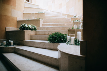 Wedding floral decoration on the stairs with white candles