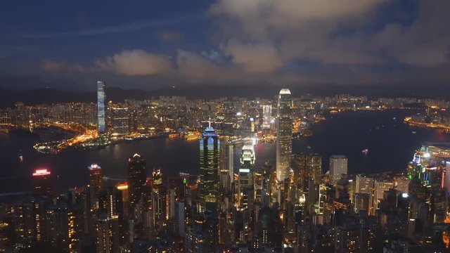 night time panning right clip of victoria harbour and hong kong island from the peak in hong kong, china