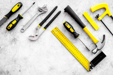 Repair tools. File, hummer, corner ruler on grey background top view copy space pattern