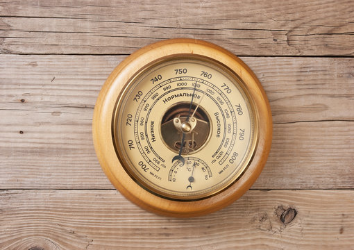 aneroid barometer on a wooden wall