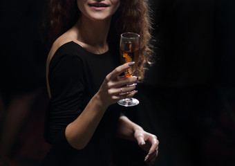 stylish young woman raising a glass of champagne