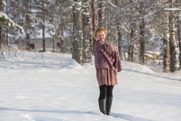Fototapeta na wymiar Young russian woman posing in a snowy park in winter.
