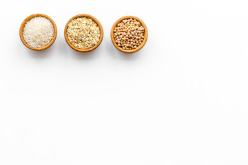 Healthy breakfast. Various cereals in bowls on white background top view copy space