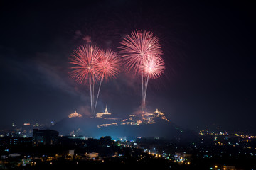 Beautiful red fireworks at night with temple on mountain view