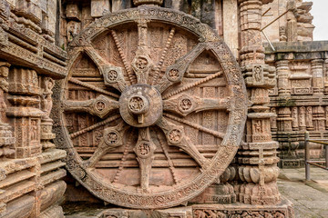 Fototapeta na wymiar Intricate carvings on a stone wheel in the ancient Hindu Sun Temple at Konark, Orissa, India.