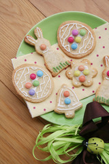 Obraz na płótnie Canvas Easter glazed cookies in shape of egg, bunny, flower and bell on wooden background