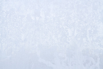 Winter frosty patterns on the frozen ice window