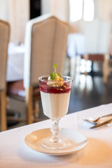 Panna Cotta in a cup, on the table in the restaurant