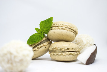 Vanilla coco macaroons desert with fresh coconut and mint leaves on white background