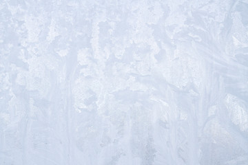 Winter frosty patterns on the frozen ice window