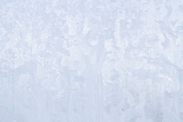 Winter frosty patterns on the frozen ice window