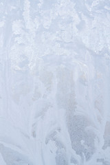 Winter frosty patterns on the frozen ice window