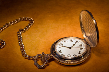 pocket watch on old paper background
