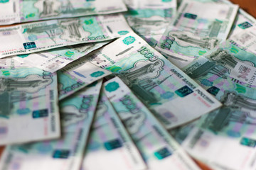 money, Russian banknotes in denominations of one thousand rubles scattered on the table