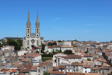 Fototapeta na wymiar Rooftop view of the historic town of Niort and St Andre's church, in the Deux-Sèvres department in western France. 