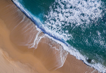 Aerial view of a paradisiacal beach with waves