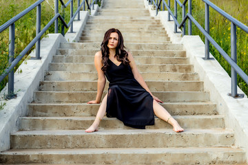 young beautiful girl is sitting on the stairs