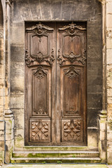 Ancient wooden entrance door to the Basilica of Saint Denis. Saint-Denis, France - 193453236