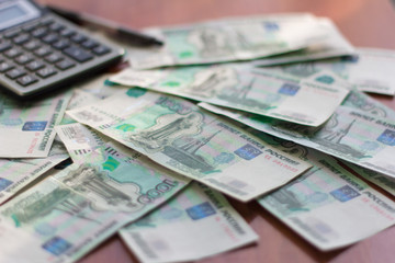 money, Russian banknotes in denominations of one thousand rubles scattered on the table